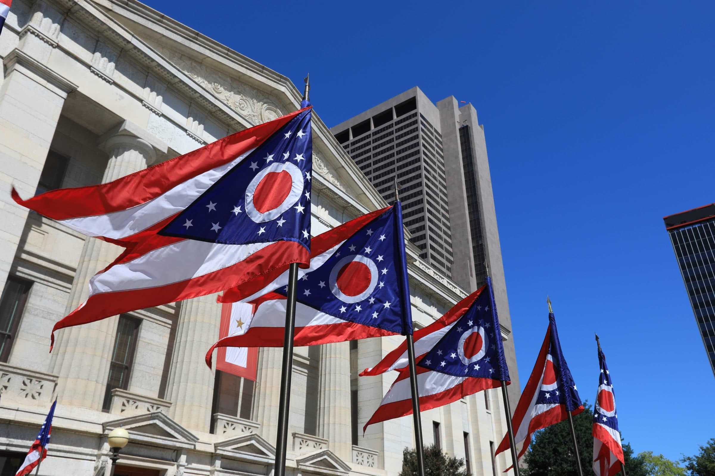 State of Ohio flags waving in front of the Statehouse in Columbus, OG.